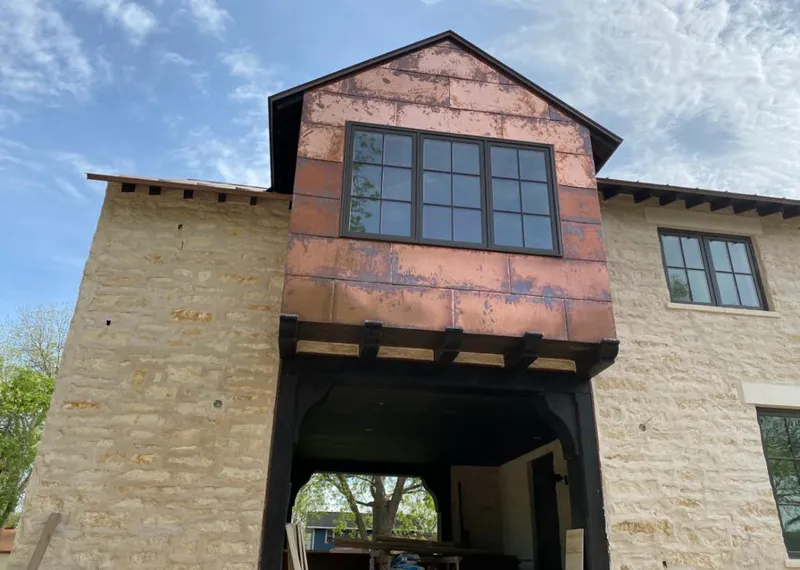 Copper metal panel facade on a stone building for Skylight Installation in Avenal